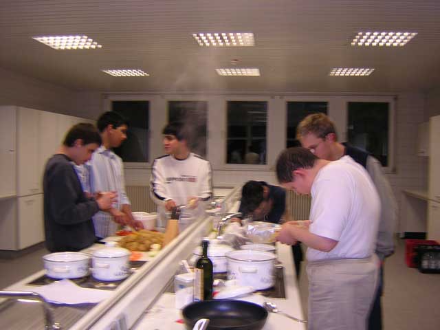 6 Jungs kochen hinter Dampfschwaden Nudel- und Kartoffelauflauf